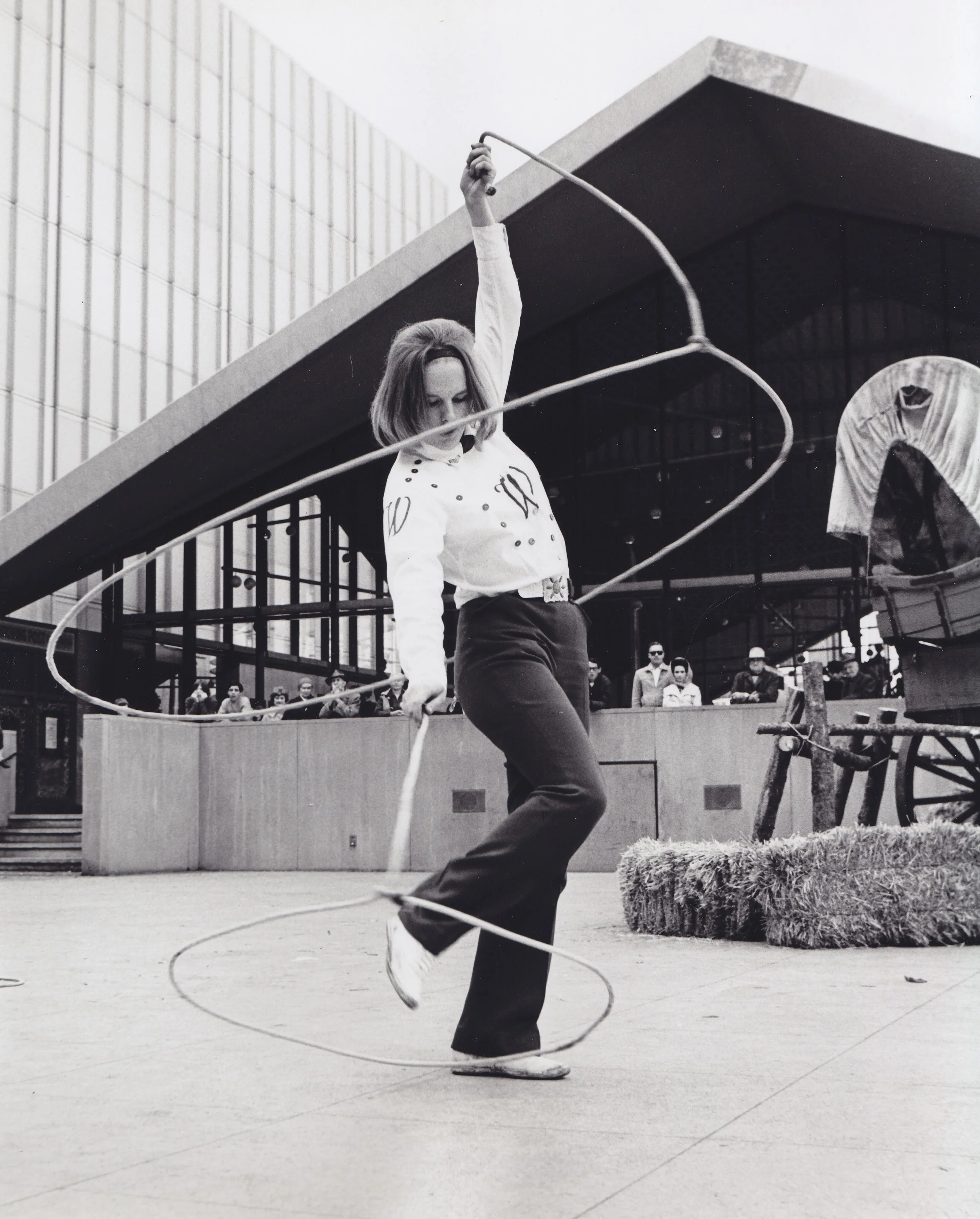 A Westernaires roper performs a "Double Wedding Ring with Toe Dance" rope trick for the public on 16th Street to promote Denver's 1967 National Western Stock Show and the 100th anniversary of the Colorado Cattlemen's Association.
