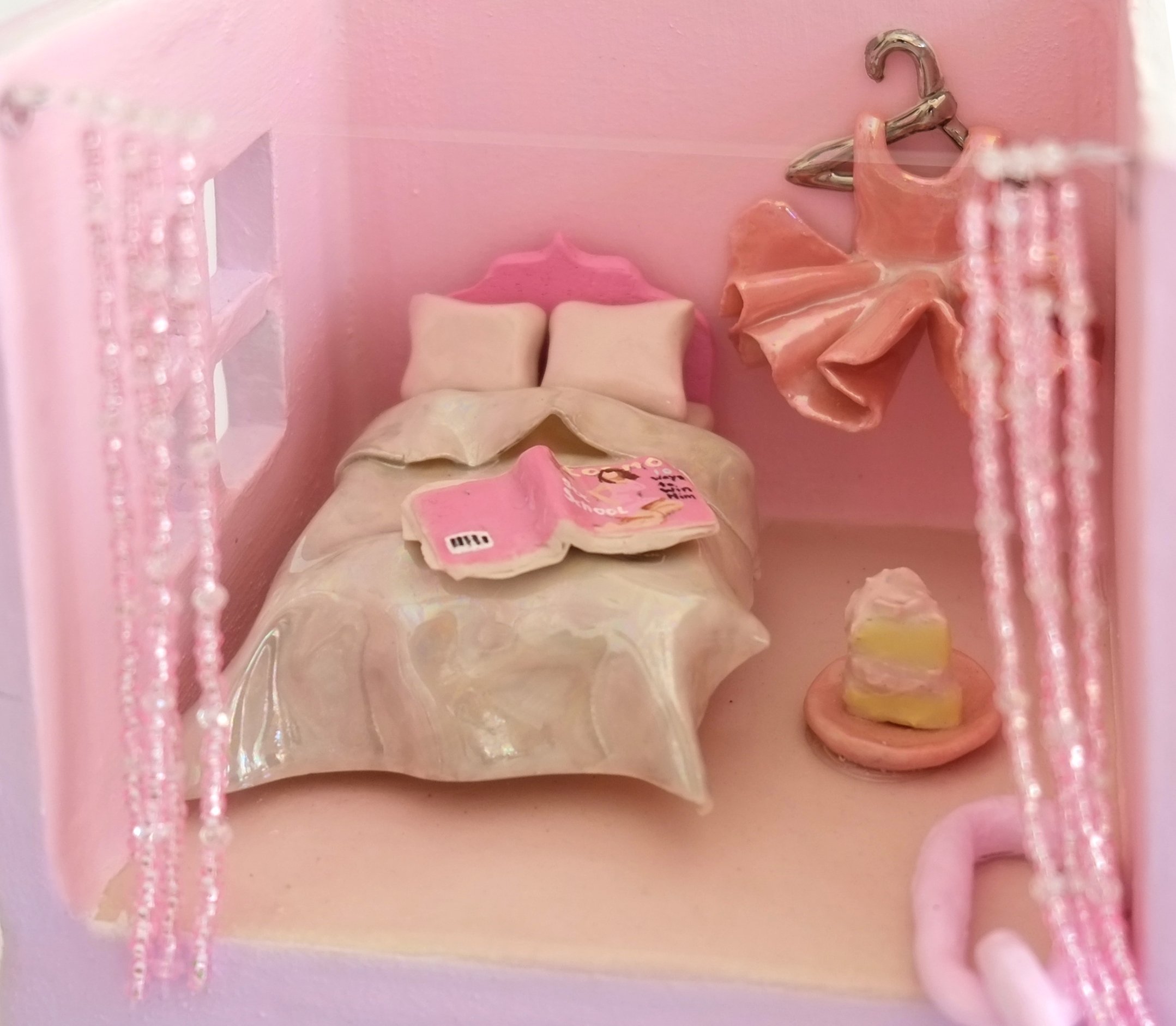 Bedroom from girlhood adorned with tutu and 2000s Cosmo Magazine