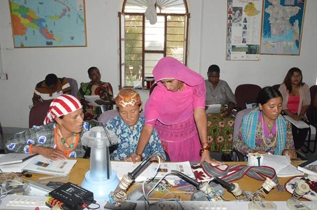 We're investing in women so they can invest in their communities. You'd be surprised how much income gets eaten up by paying for flash light batteries, kerosene, and other tools to light up a house. Instead, we teach women to power their homes throug