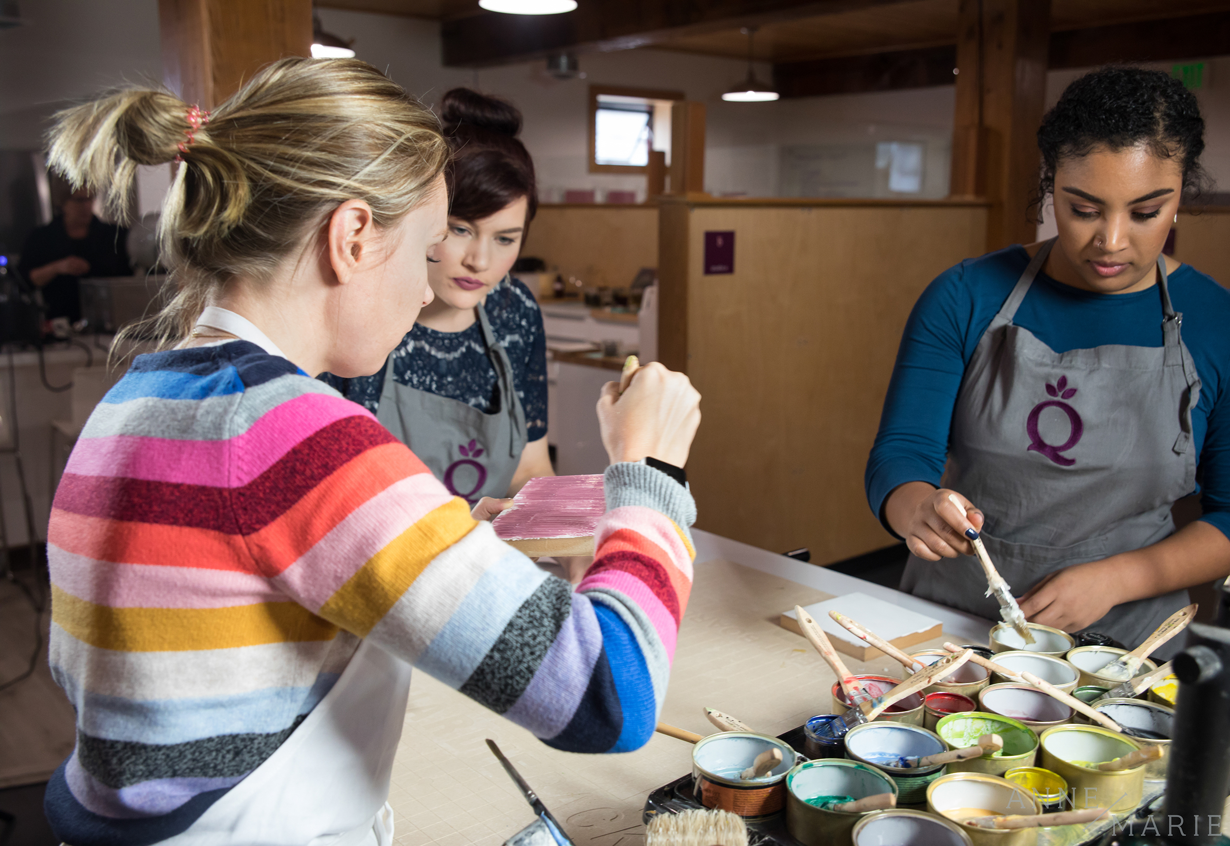  (From left to right) Anne-Marie, Kelsey and Kayla start their encaustic projects. 