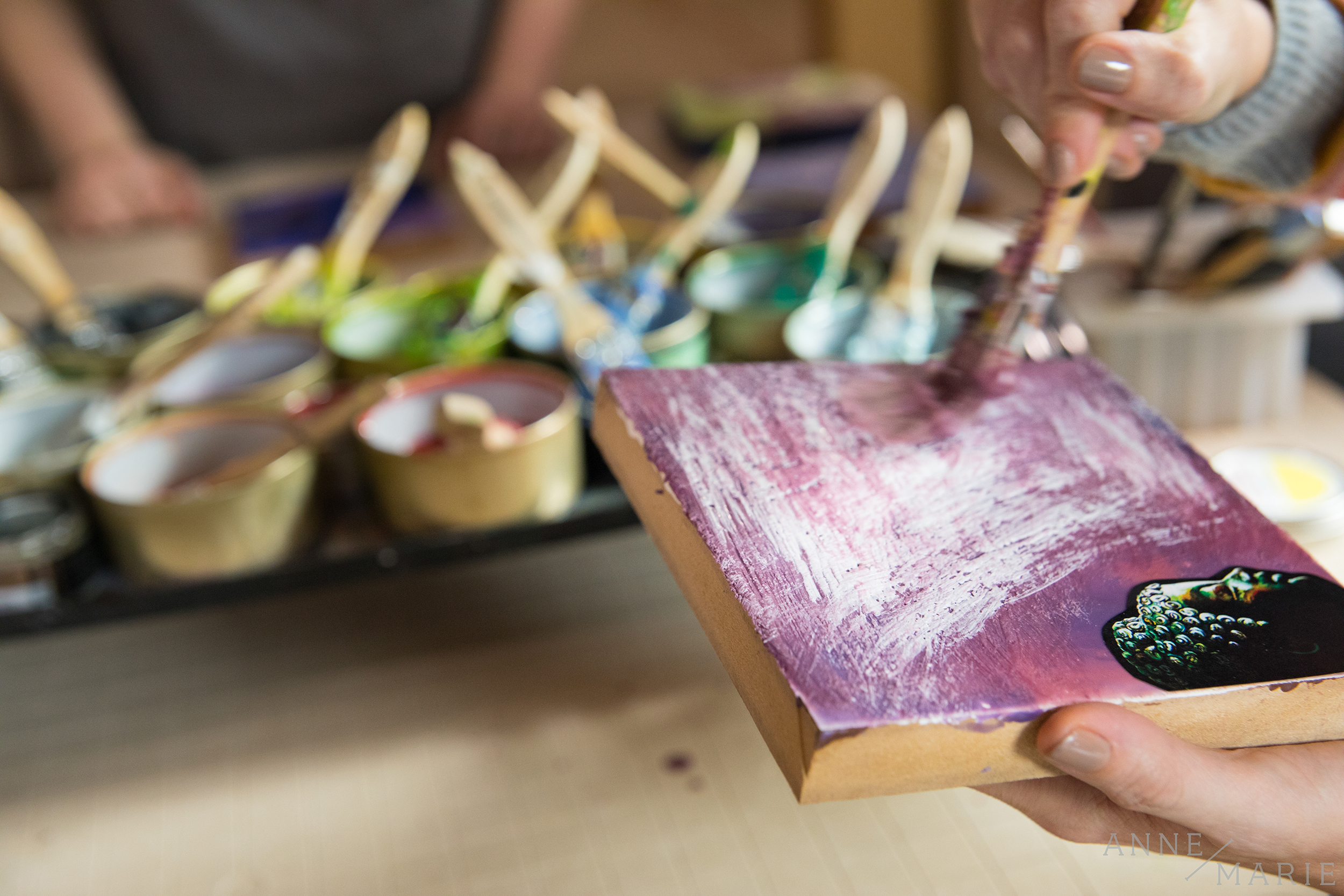 Etching designs into the wax and then painting over it created interesting textures. Photos could also be added and painted over to create collages.