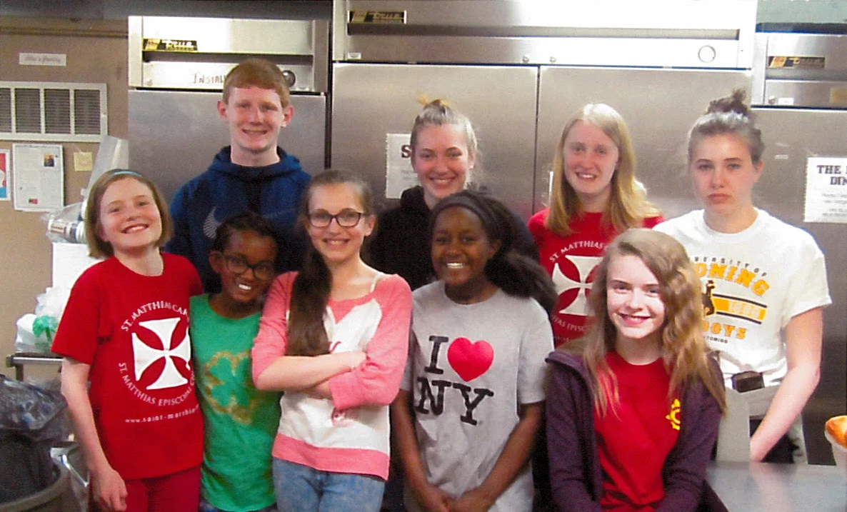 Kids and youth helping serve dinner during the Lord's Supper