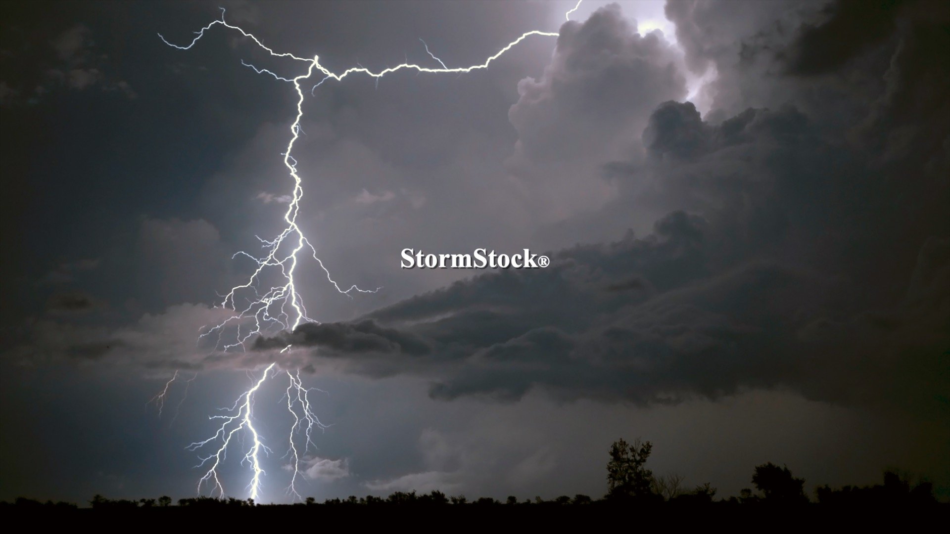 A forked lightning bolt strikes the ground at night, Kansas