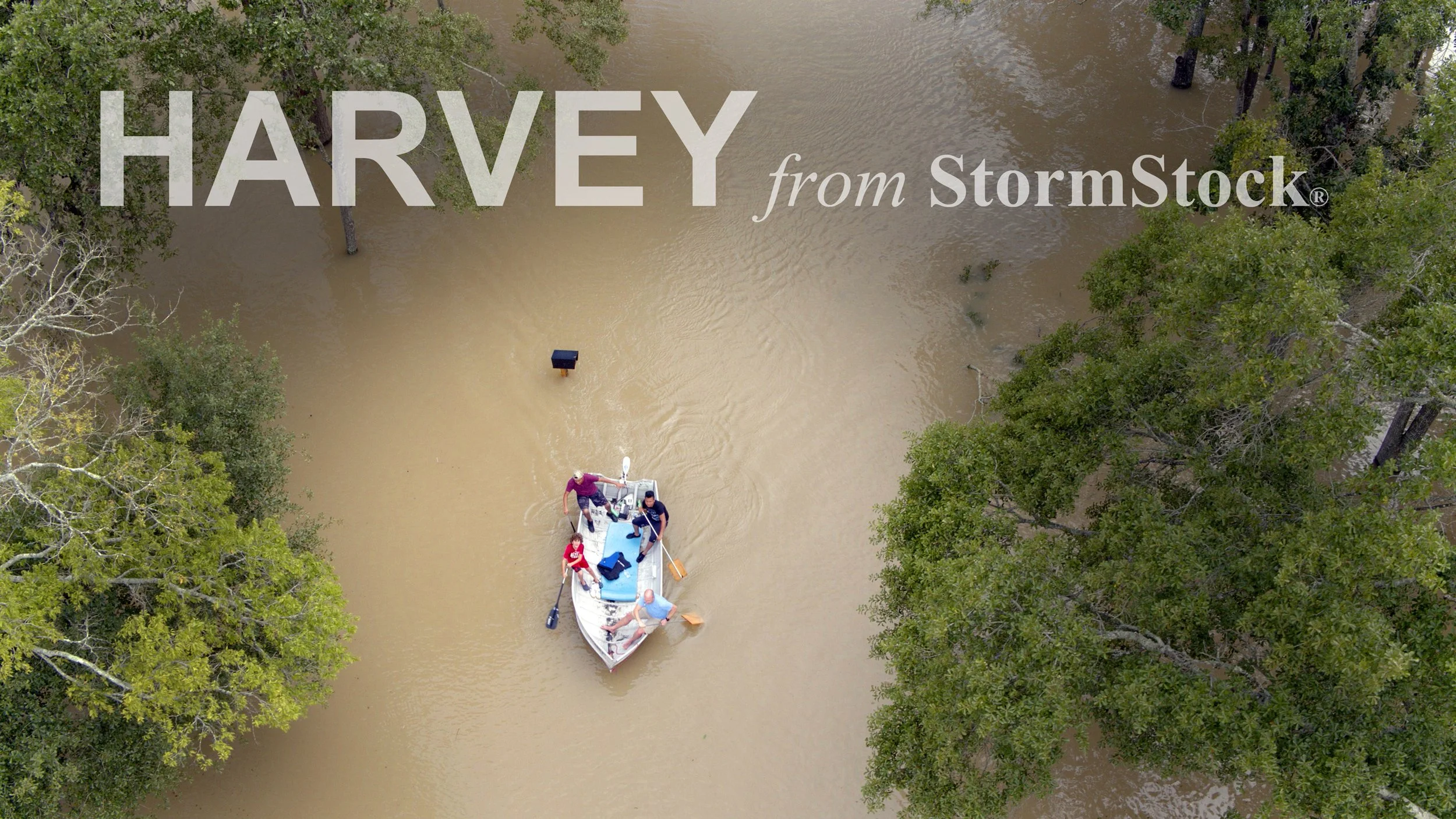 Aerial shot of citizens in boat escaping down flooded street, Houston, Texas, Hurricane Harvey