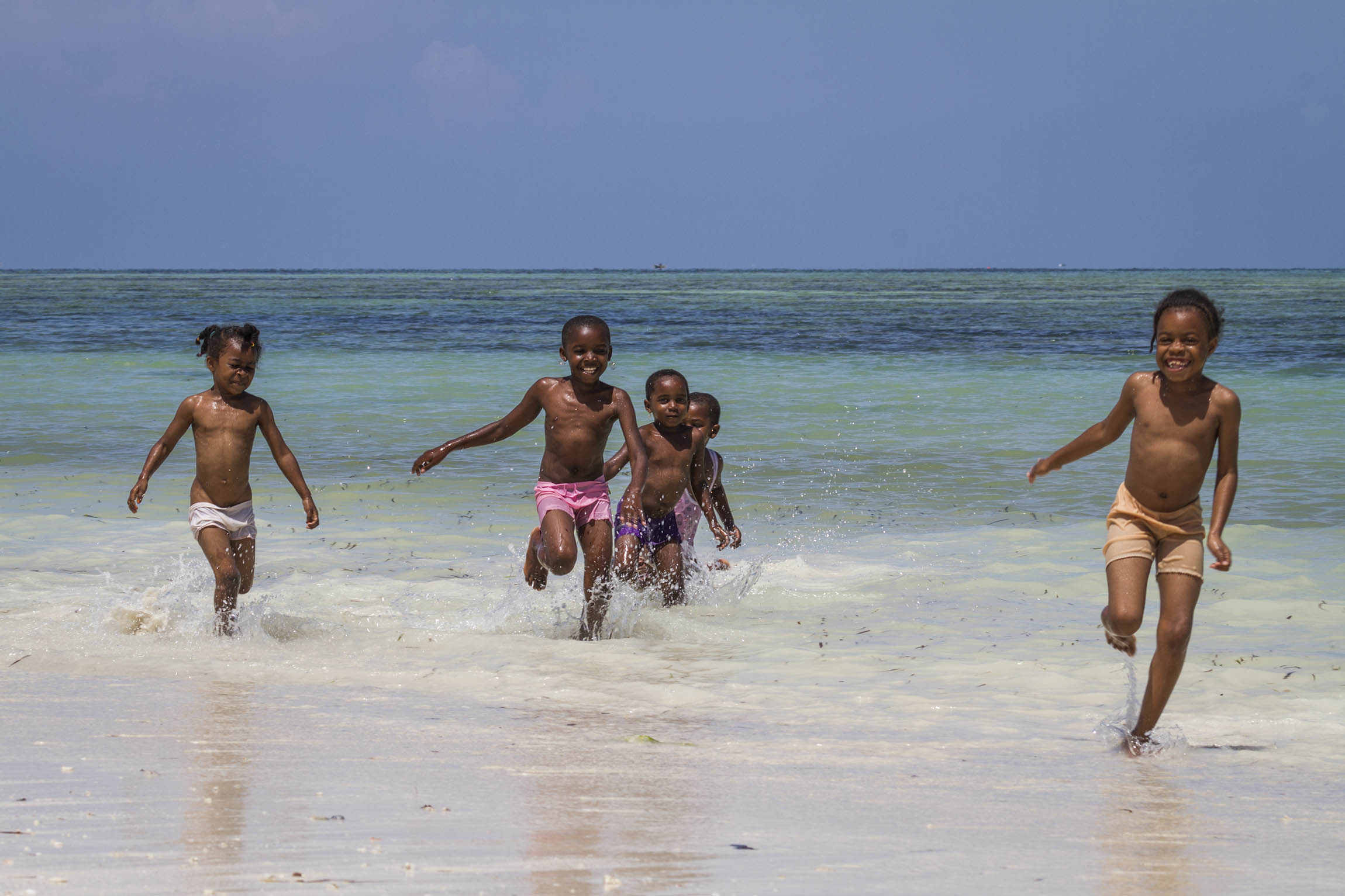 Zanzibar, Tanzania. Happy kids running to greet us.