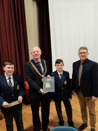 1st years presenting cheque for Lord Mayors Charity and Pres 140 book