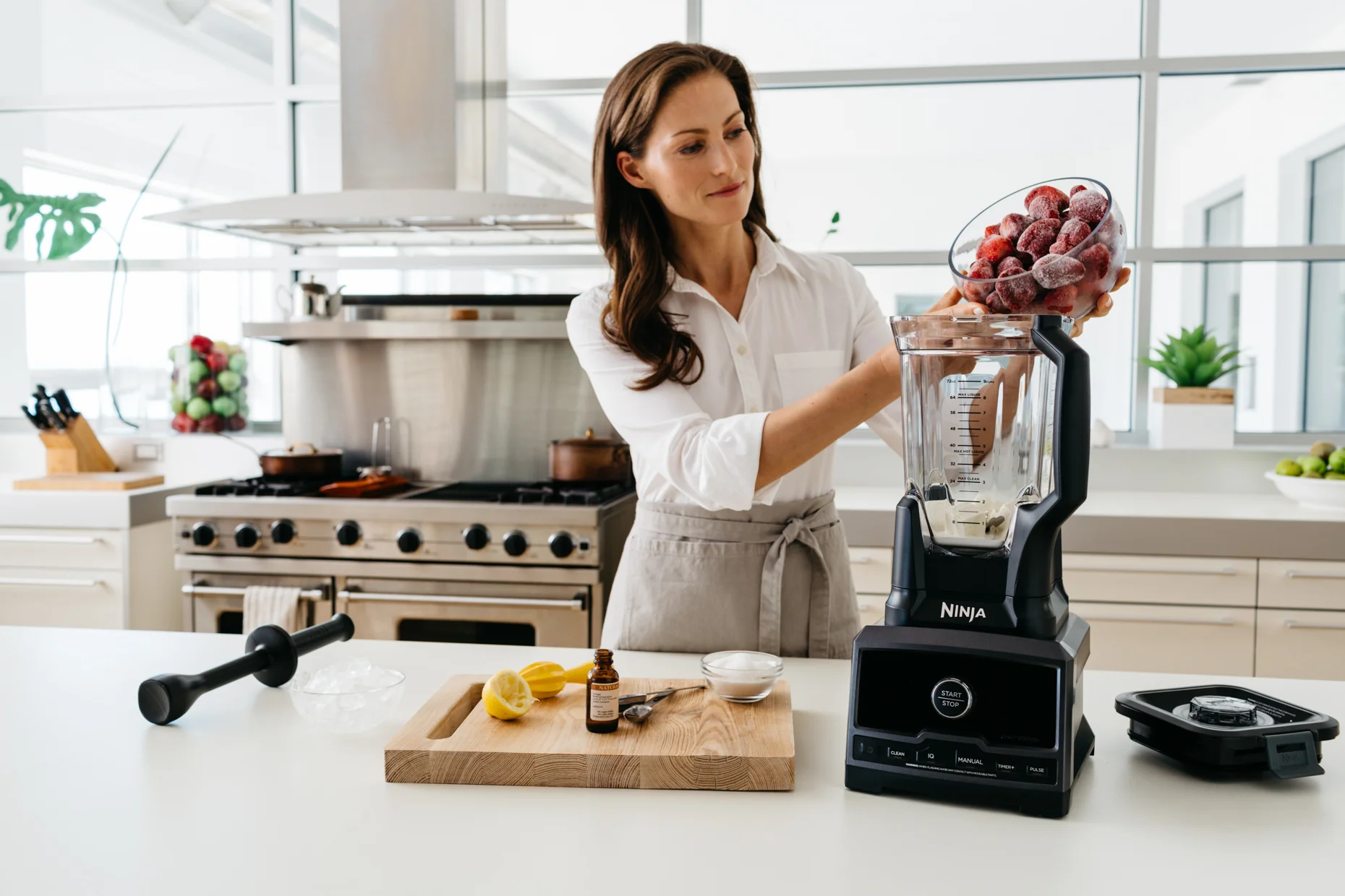 Woman-Putting-Frozen-Strawberries-into-Blender.jpg