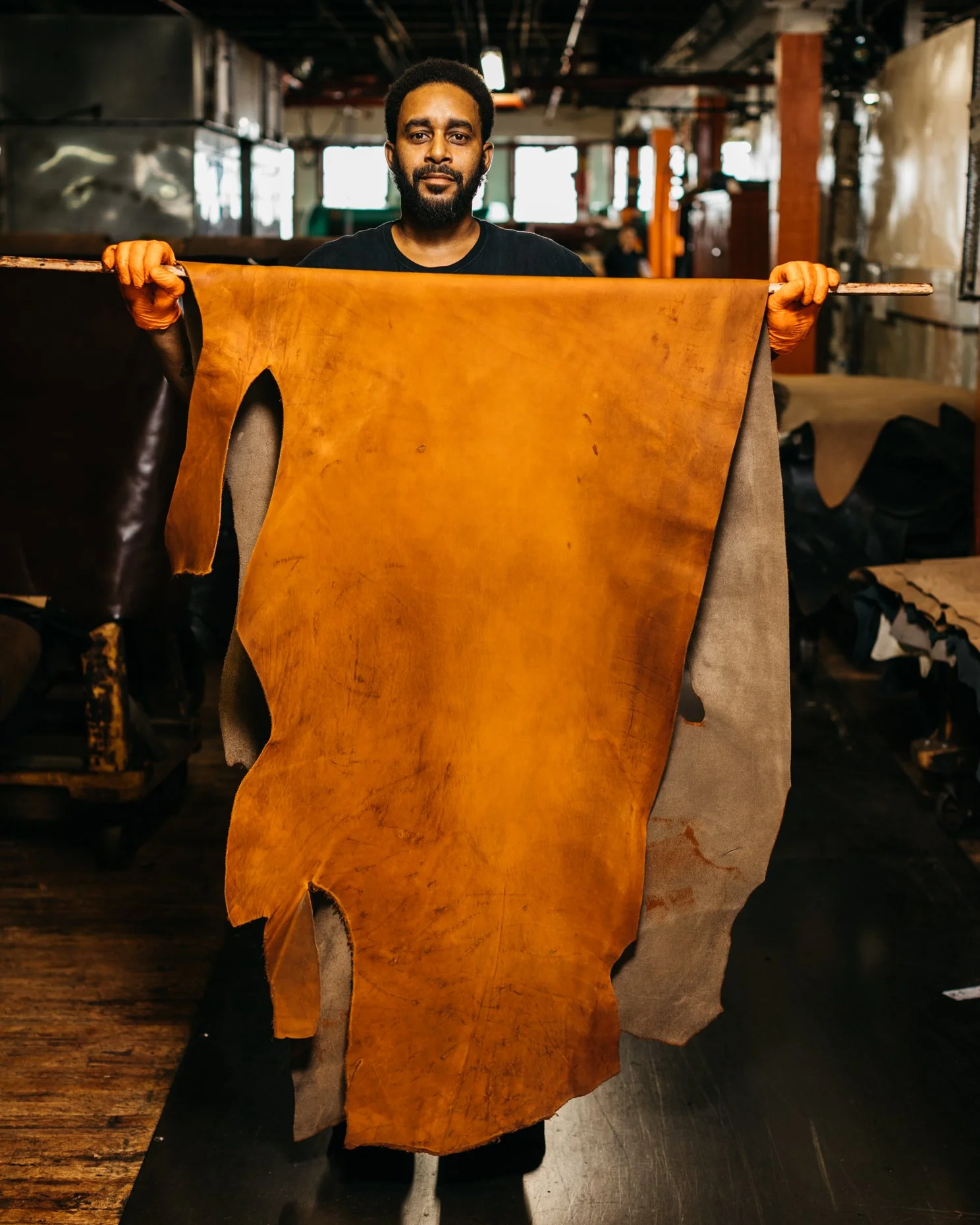 Man-Holding-Dried-Hide-Horween-Tannery-Chicago.jpg