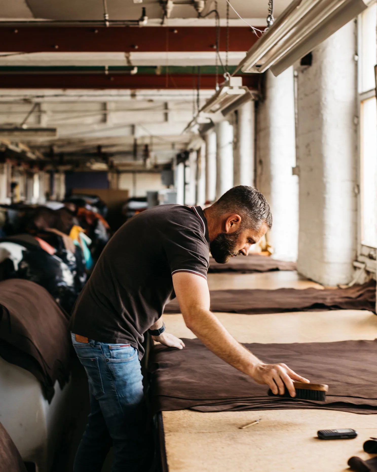 Man working on piece of leather in a workshop