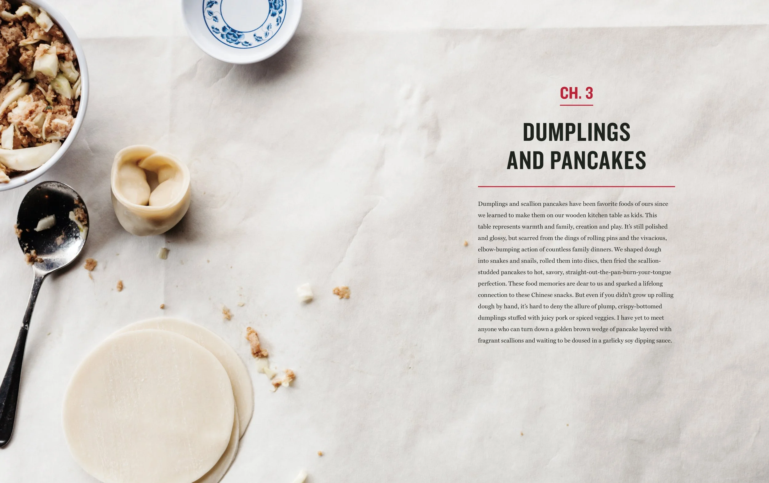 A partially prepared setting for making dumplings and scallion pancakes, with a stack of pancakes, a spoon with stuffing, a small bowl of filling, and an egg, on a white paper surface with text about dumplings and pancakes.