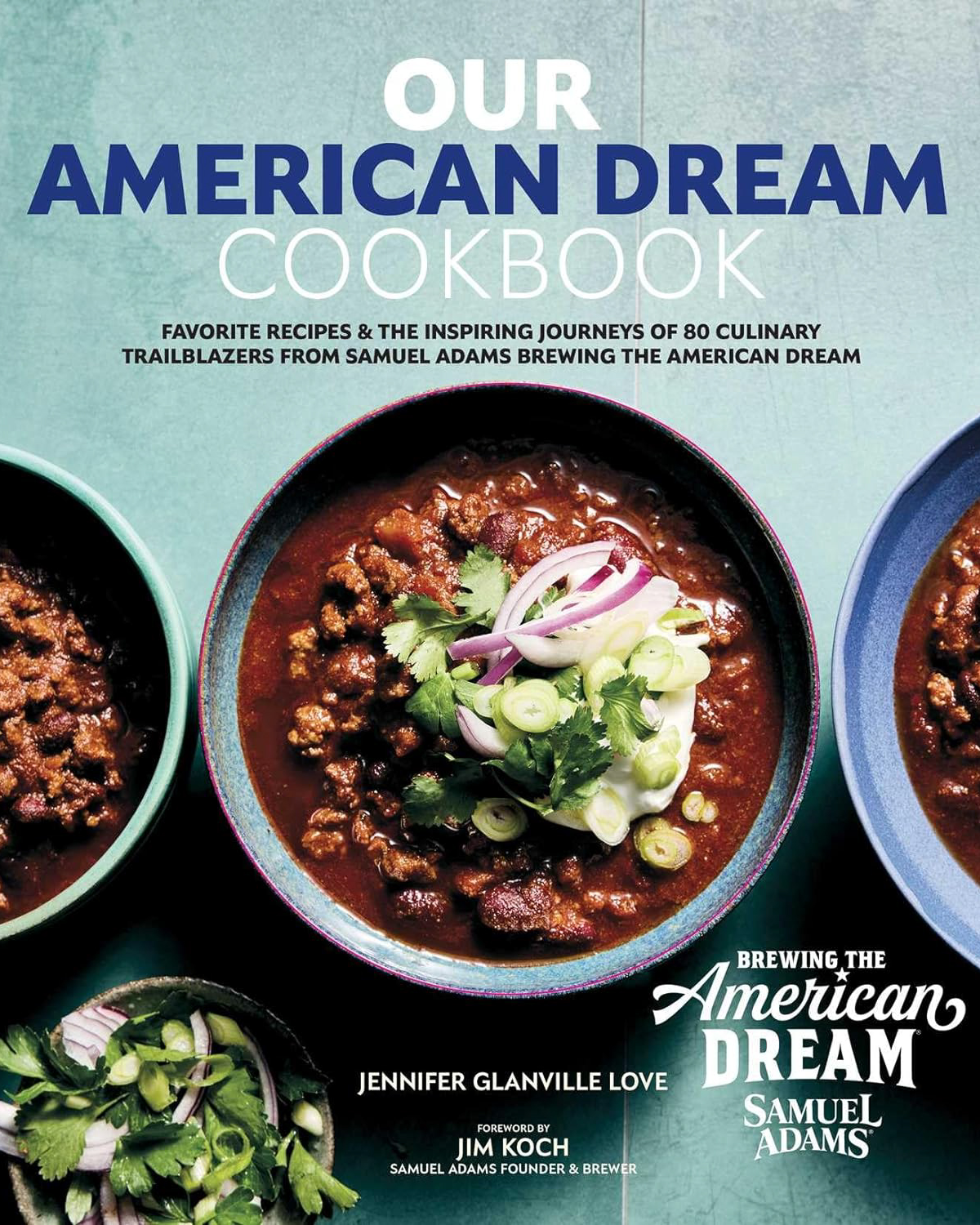 Cover of a cookbook titled "Our American Dream Cookbook" featuring bowls of chili garnished with onions and cilantro.