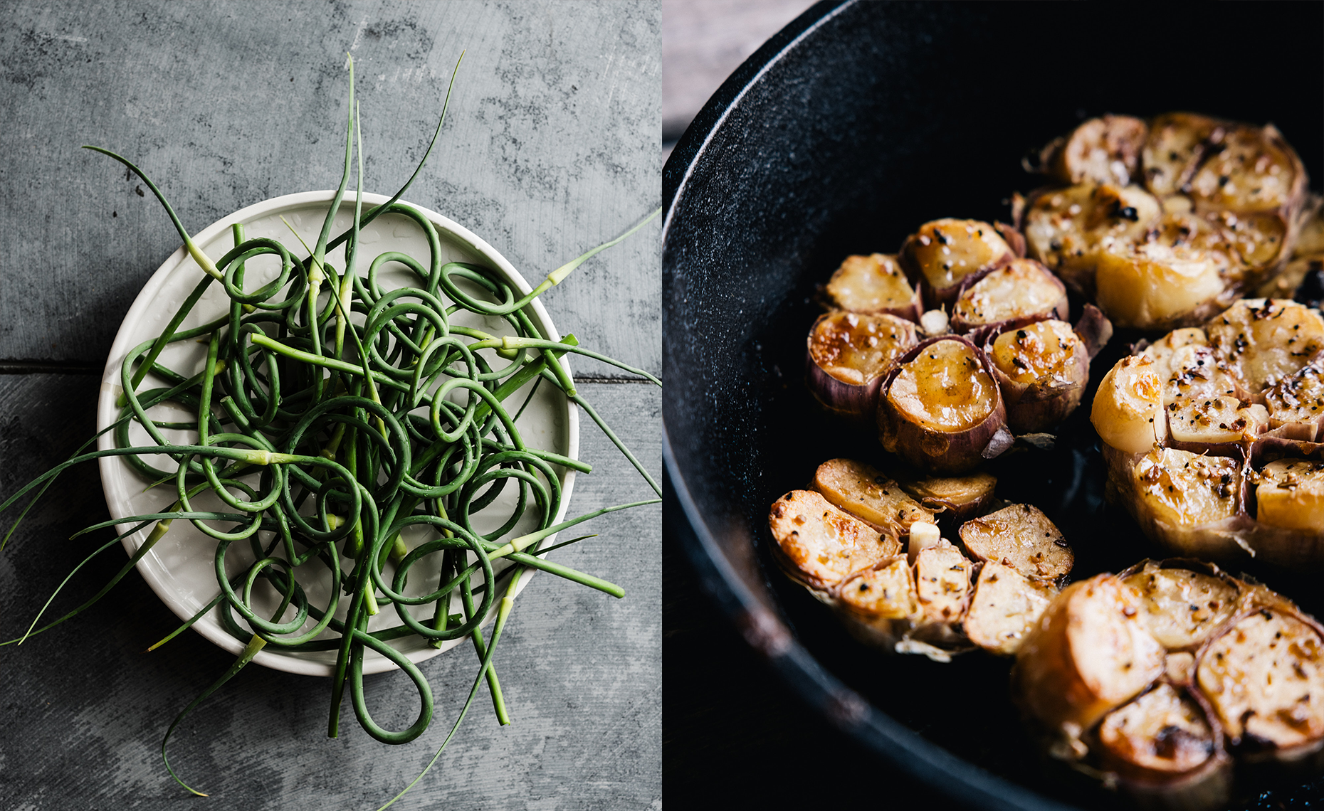 A white bowl filled with fresh garlic scapes on a gray surface, next to a black skillet with roasted heads of garlic.