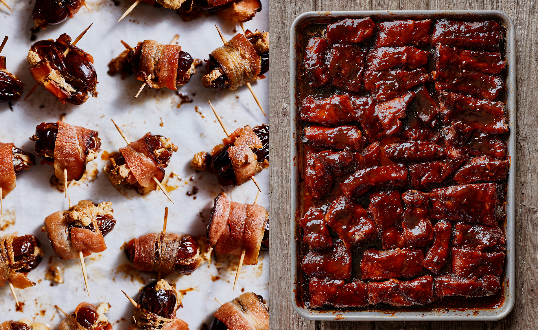 Bacon-wrapped dates with toothpicks on parchment paper next to a tray of glazed barbecue ribs.