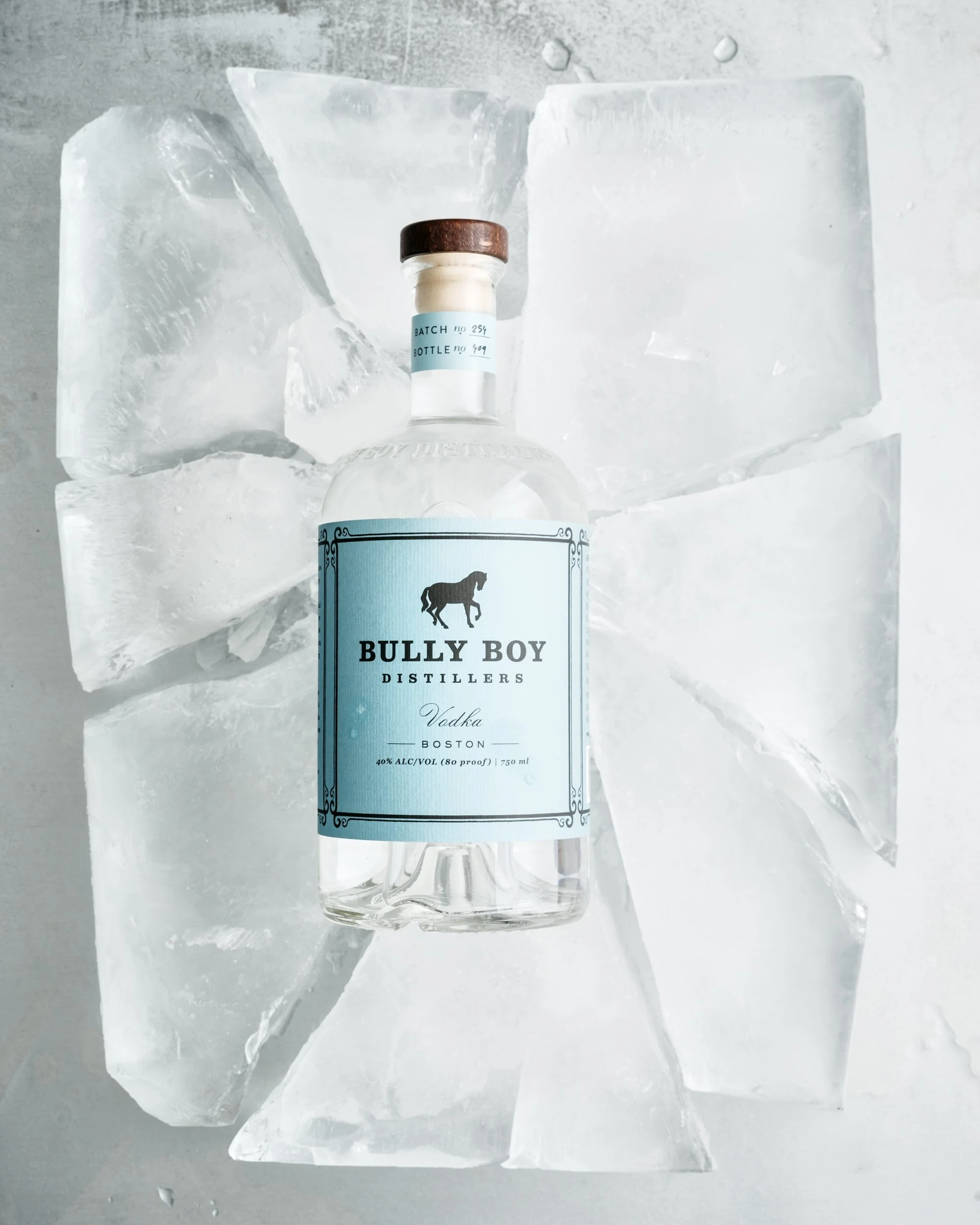 A bottle of Bully Boy Vodka placed on ice cubes.