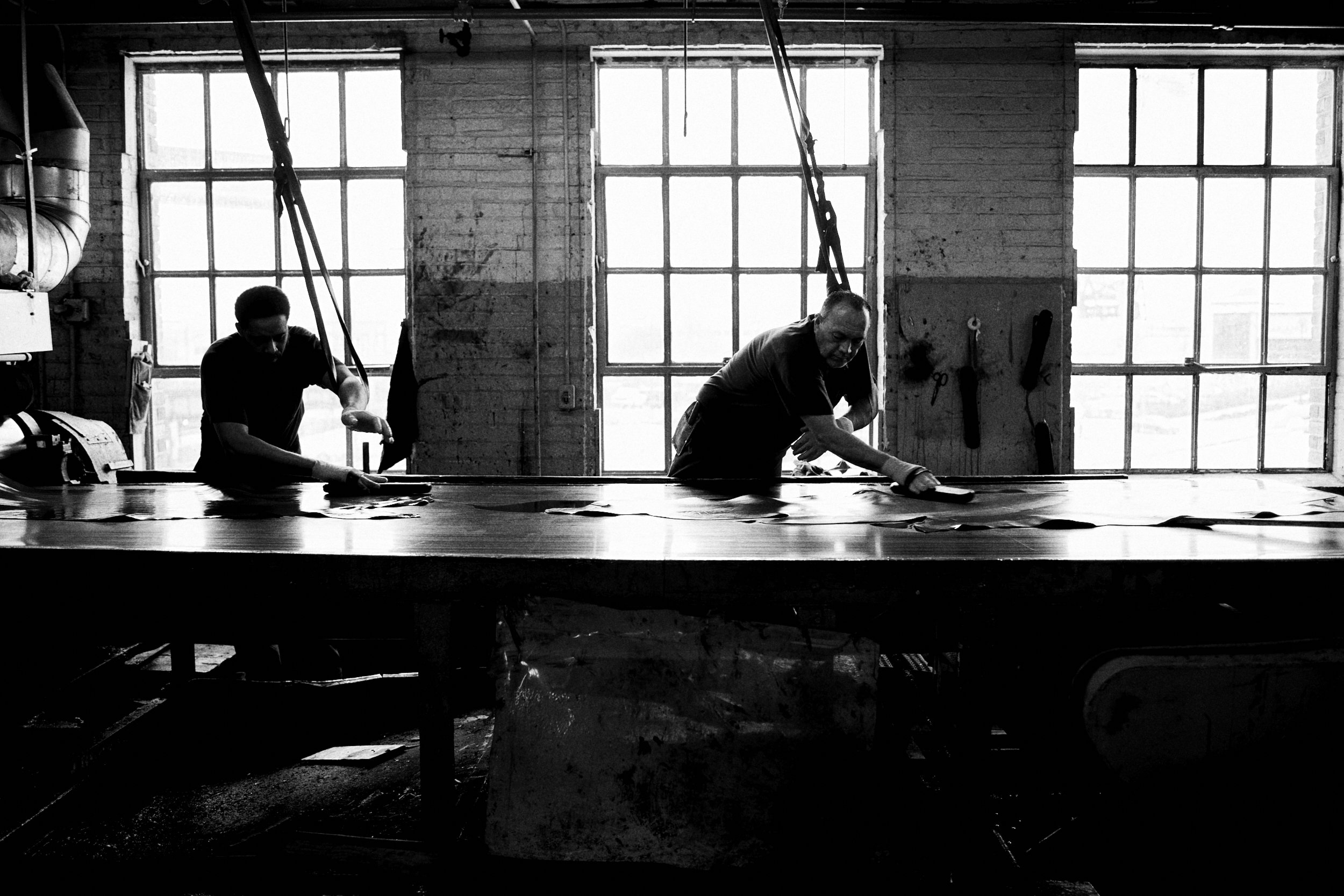 Men-Flattening-Wet-Hides-Horween-Tannery.jpg