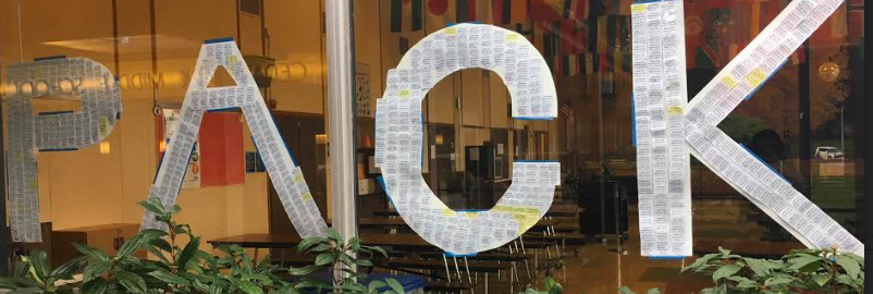Earned PACK tickets decorate the cafeteria windows.