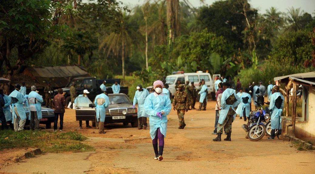 Photo by Michael G. Seamans Sierra Leone military personnel and government healthcare workers begin a sweep in the village of Ndogboie in the Nimiyama Chiefdom in eastern Kono District on Sunday, Dec. 14, 2014.