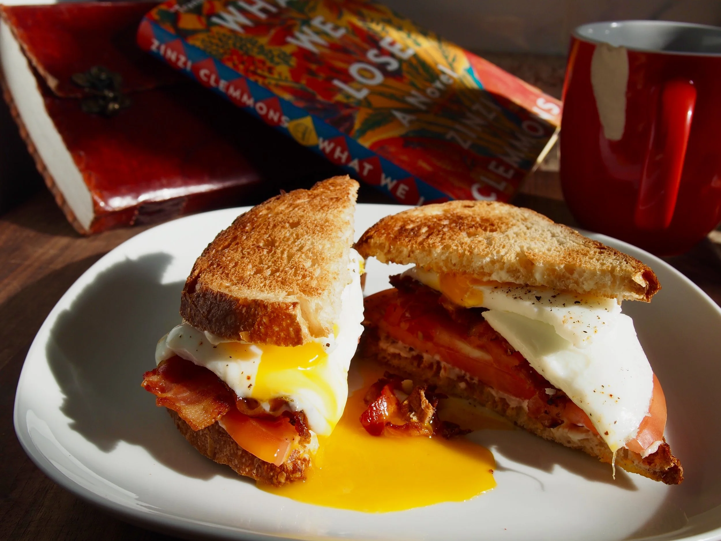 Ingredients: Toasted Sourdough bread, fried eggs (sunny-side up and yolky), bacon , tomato, and mayonnaise.