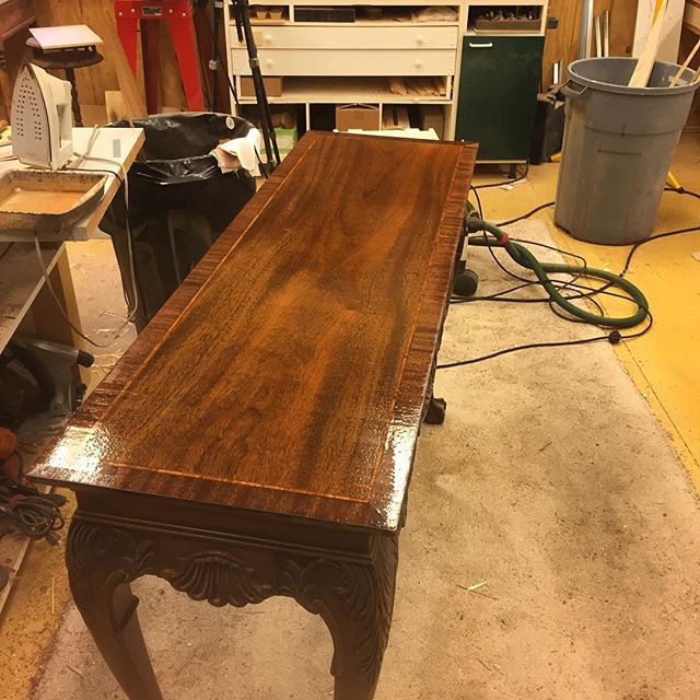 This is a hall table I'm in the process of refinishing for a customer.  The tabletop was damaged.  I removed the old finish, replaced the outer edge with mahogany, and re-stained to match.  I'm now rebuilding the finish in order to polish to a mirror