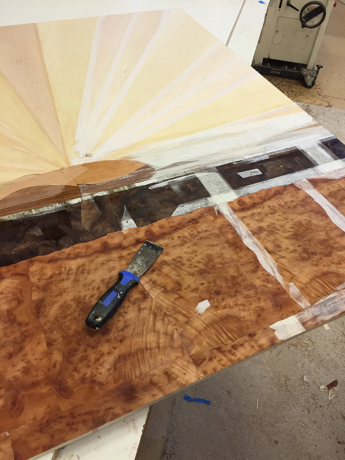 Removing veneer tape from the display's background.