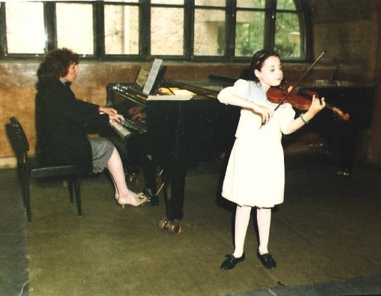 Performing at a recital with my Mom in second grade