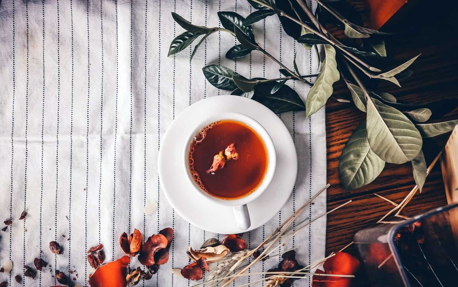 oolong tea cup on table cloth with leaves