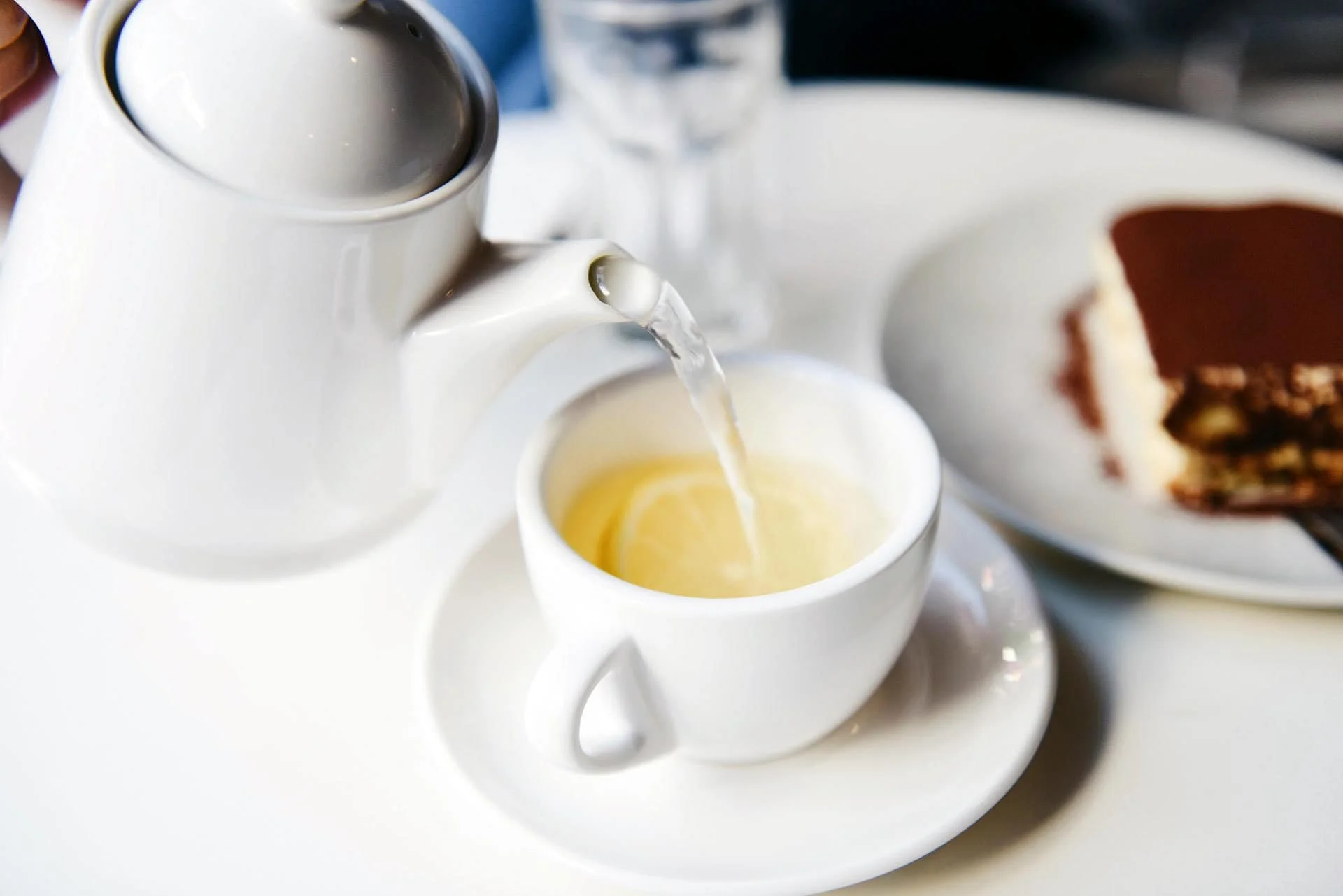 pouring white tea in ceramic cup