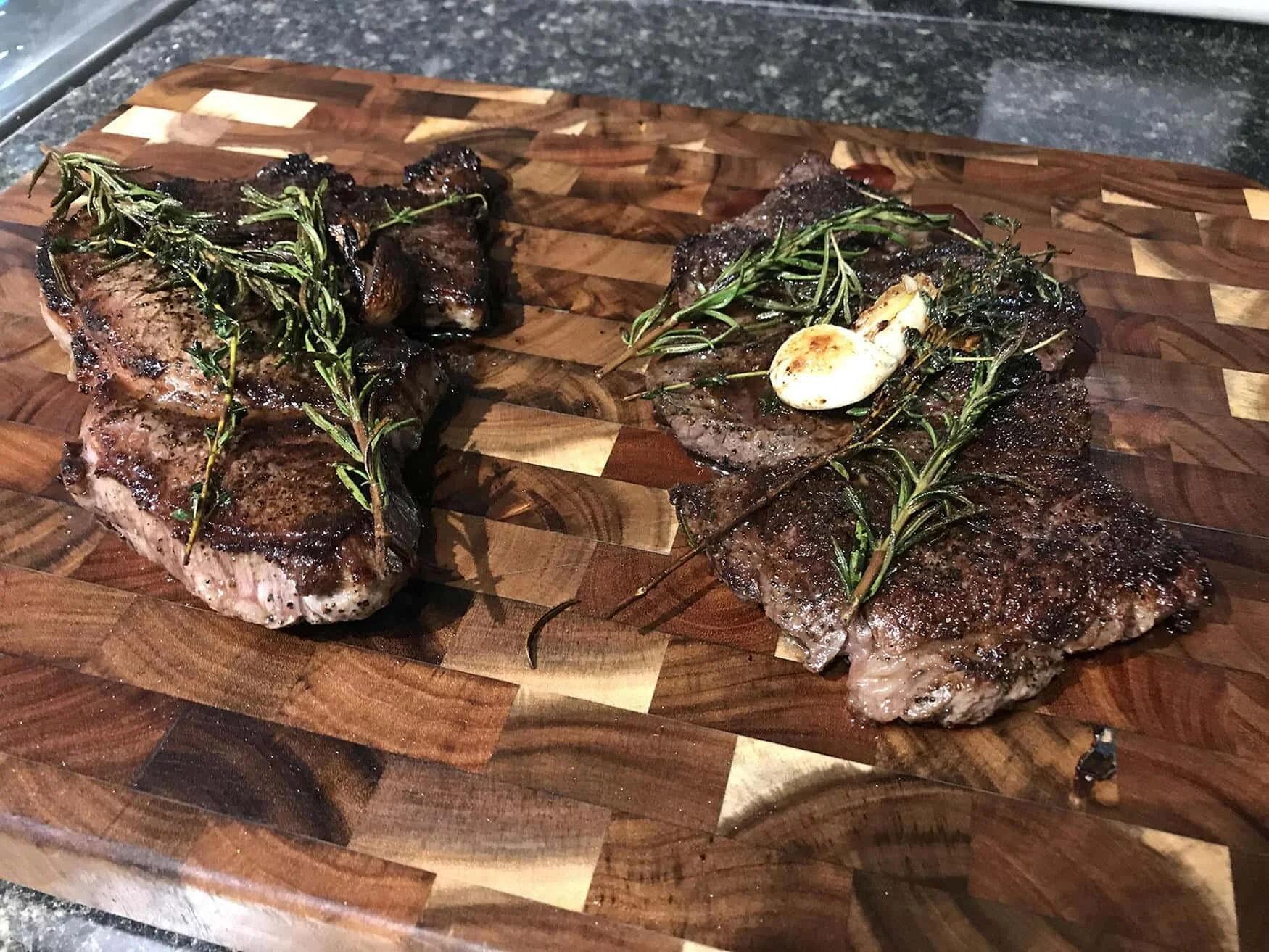 grilled steak with sprigs of thyme and butter