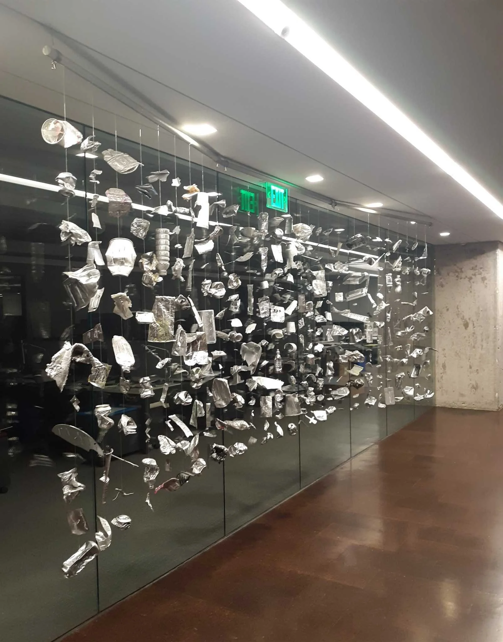 Site-responsive installation by Calvin Brett for Perkins and Will, suspended sculptural fragments in a corporate lobby