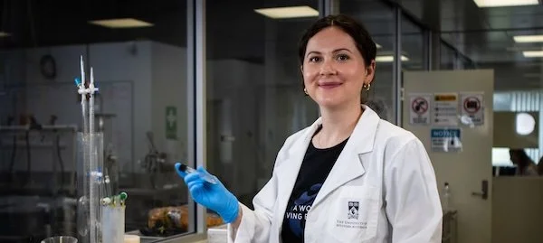 Scientist in lab smiling at camera