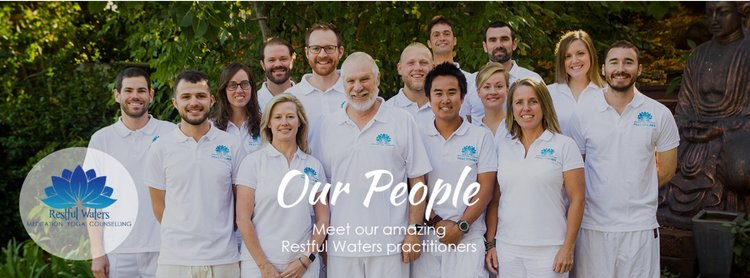 Group of people in white shirts posing outdoors for a photo, with text overlay that reads 'Our People, Meet our amazing Restful Waters practitioners' and a logo with a blue lotus flower and the words 'Restful Waters'.