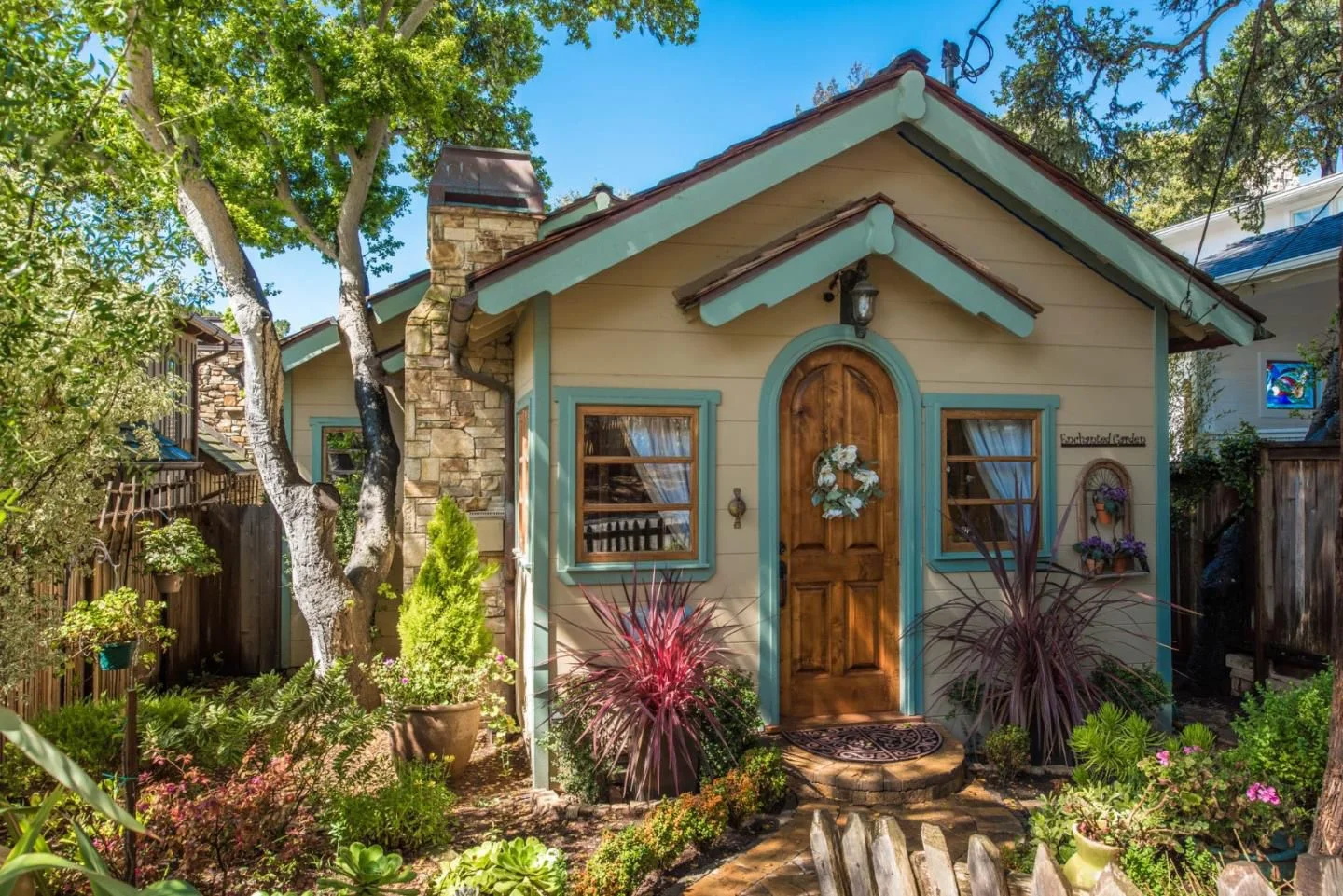 The-most-adorable-cottage-in-Carmel-is-small-with-large-space-Arched-front-door-and-teal-trim..jpg