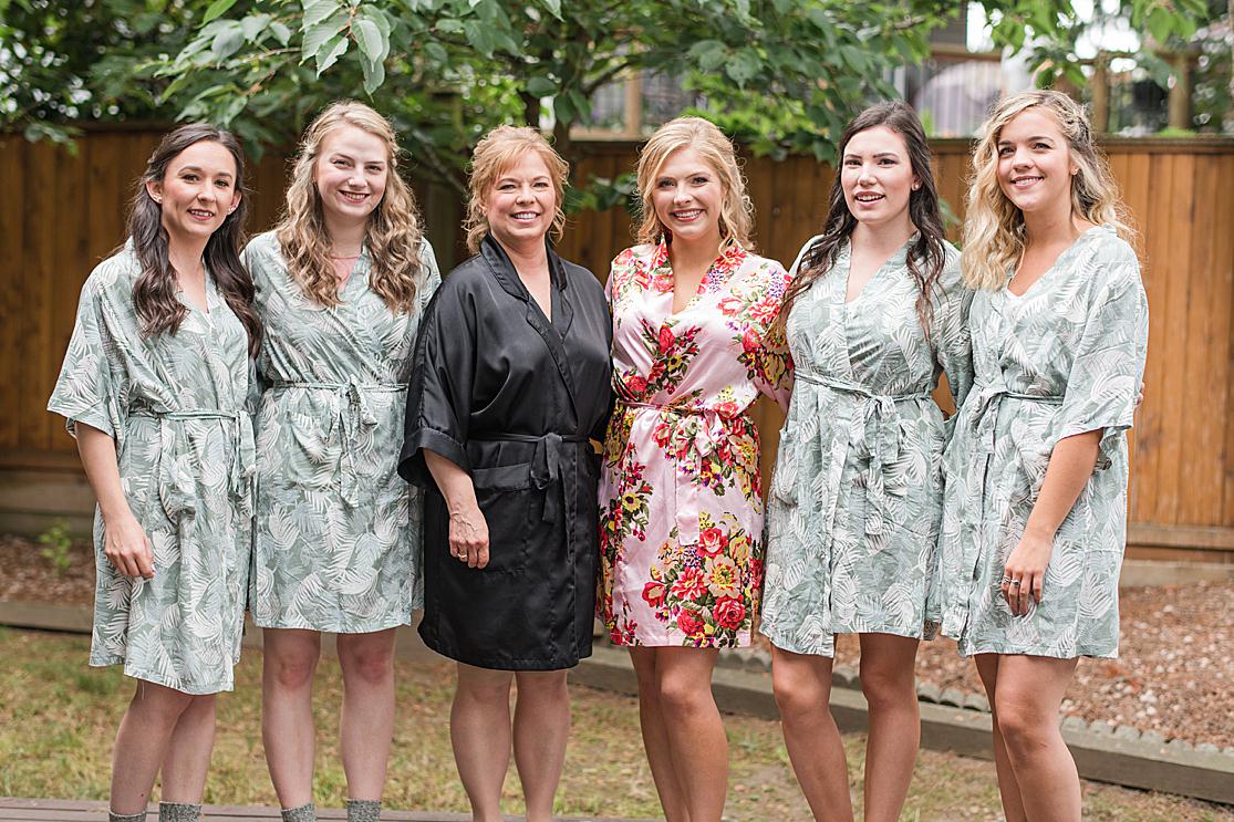 bridesmaid and bride in robes with brides mother bridesmaids getting ready taken by west midlands wedding photographer Lisa Lander