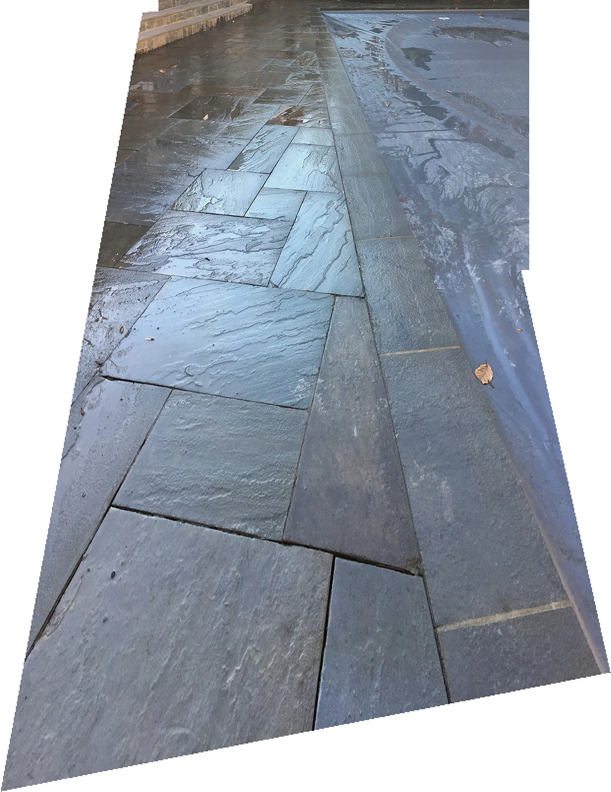 Photo showing upper deck pavement adjacent to cantilevered pavement edge. Cantilevered pavement edge conceals auto-retractable cover track.