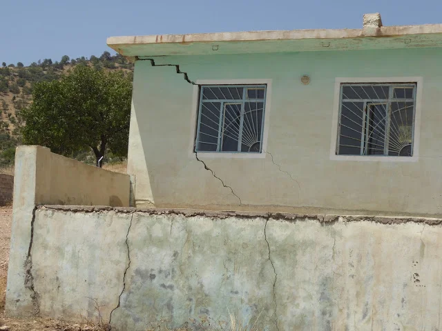 Cracks in walls of houses from bomb blasts. Photo by: Julie Brown.