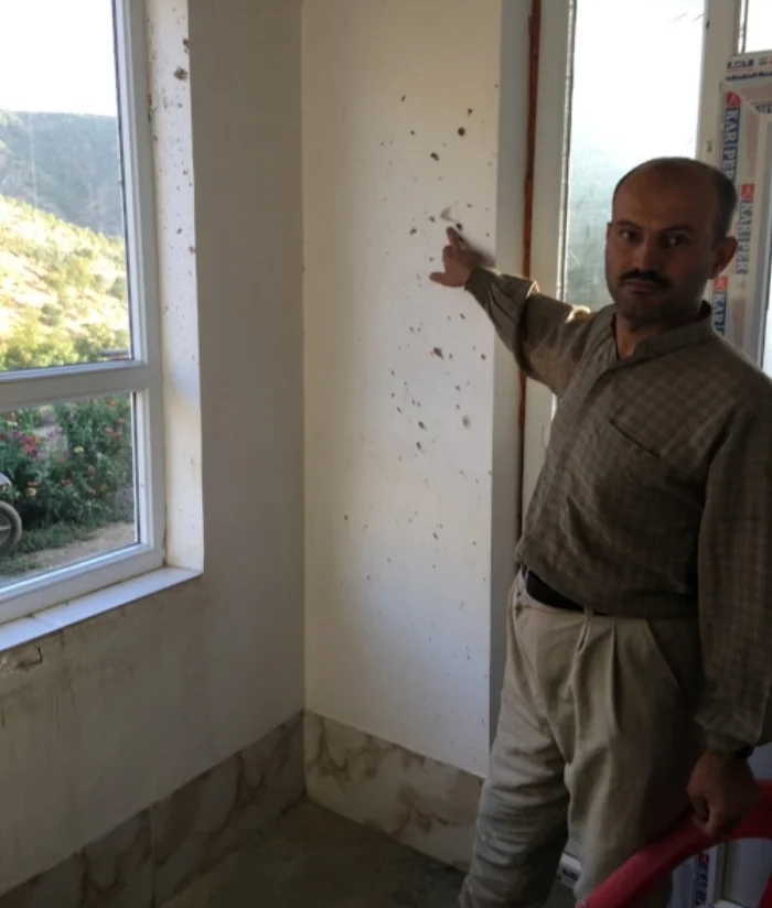 A villager showing the CPTers the damages that were caused to his house due to the Iranian bombardments.