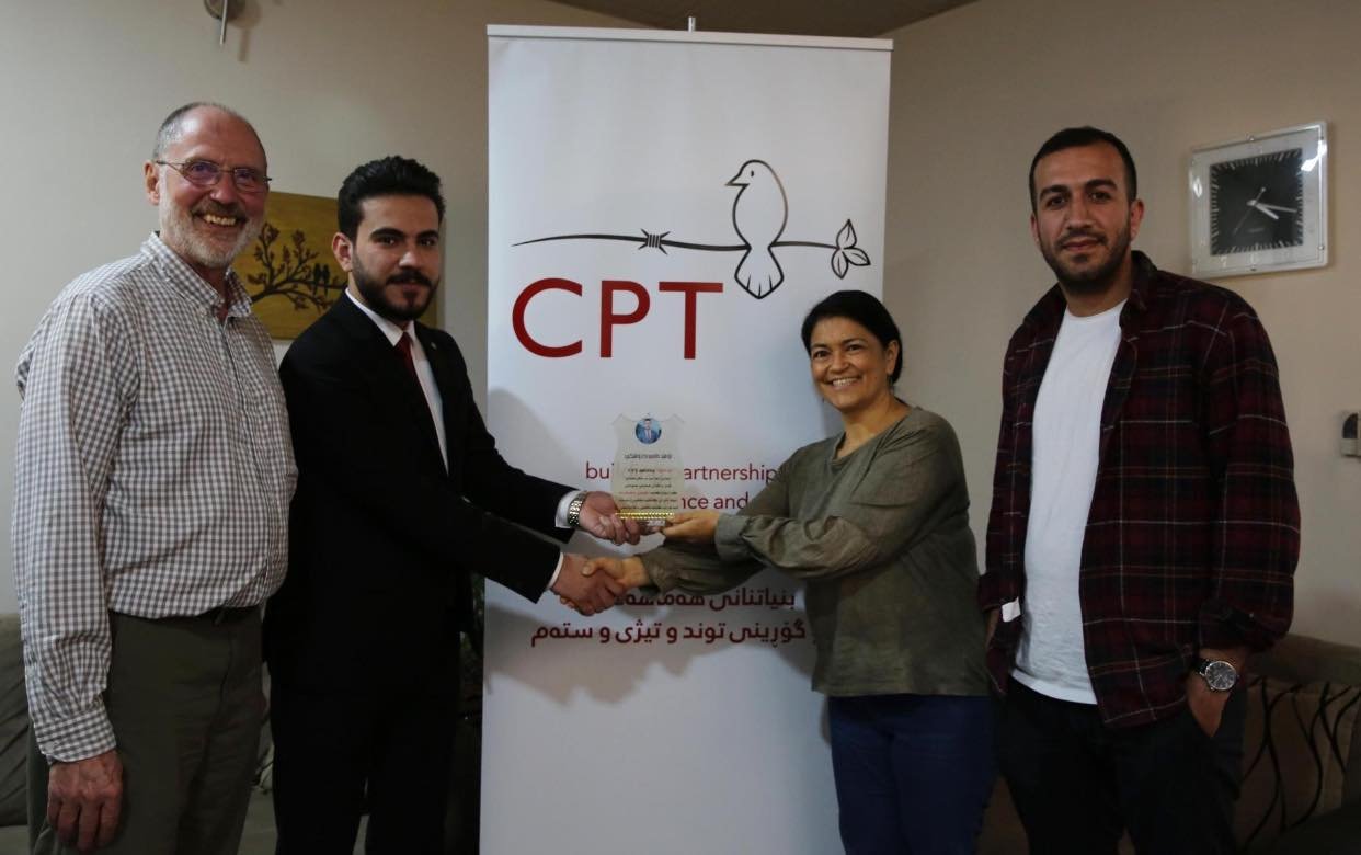 Omed Barushky presents a plaque of appreciation to CPT