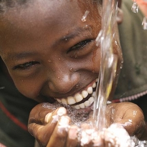 Fresh flowing water with smiling child.jpg