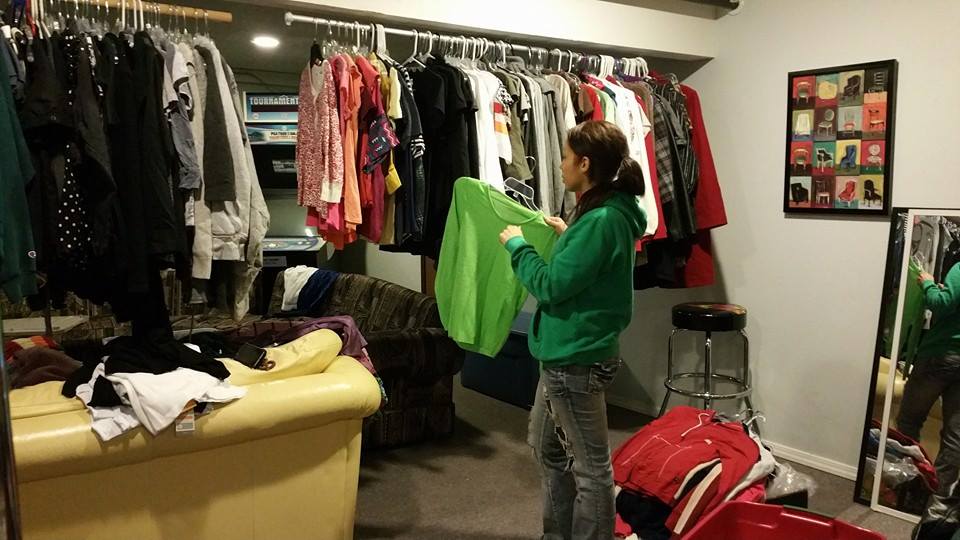 volunteer hanging clothes for the boutique.jpg