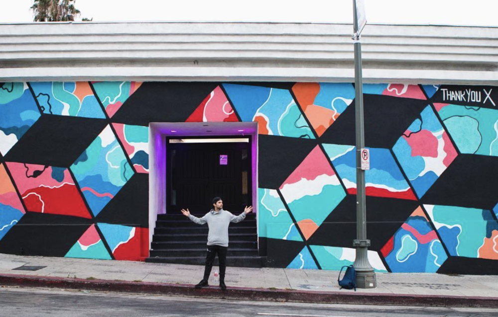 ThankYouX in front of his mural in Hollywood, CA