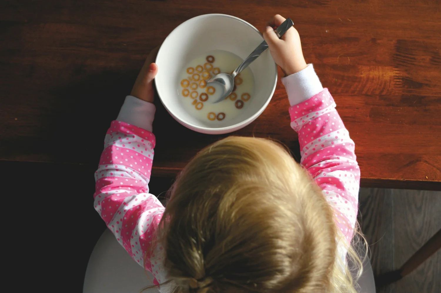 Child exploring cereal during a meal