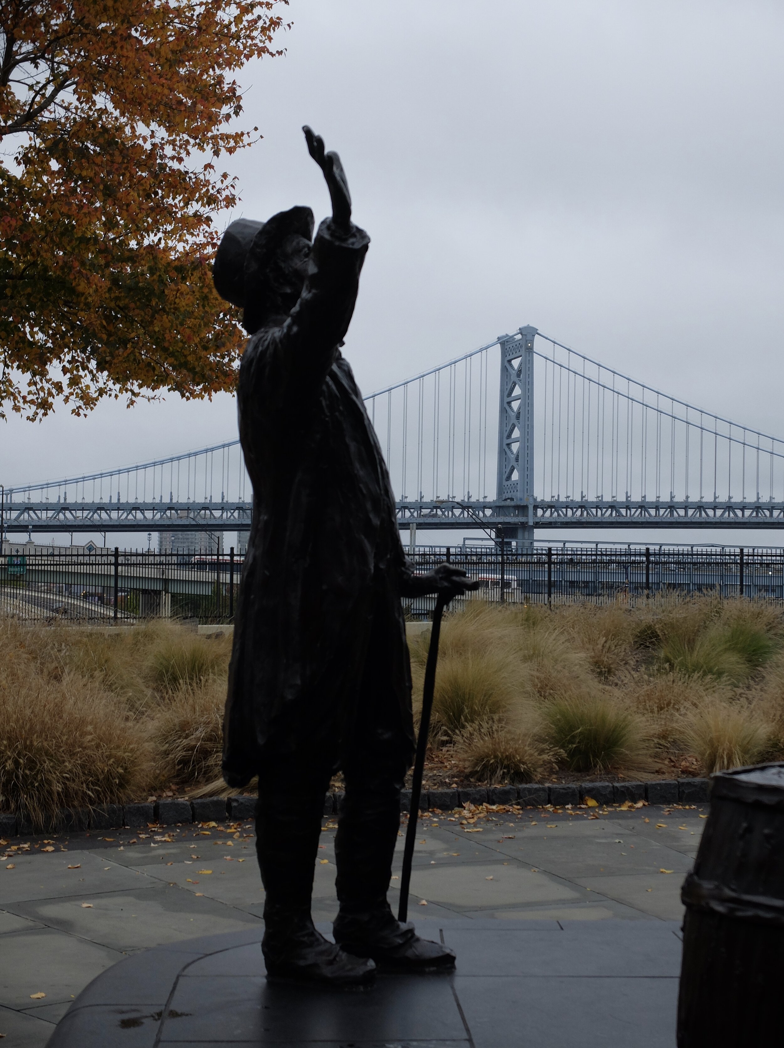 Greeting a boatload of immigrants.  Circa 1922 Ben Franklin Bridge in background.