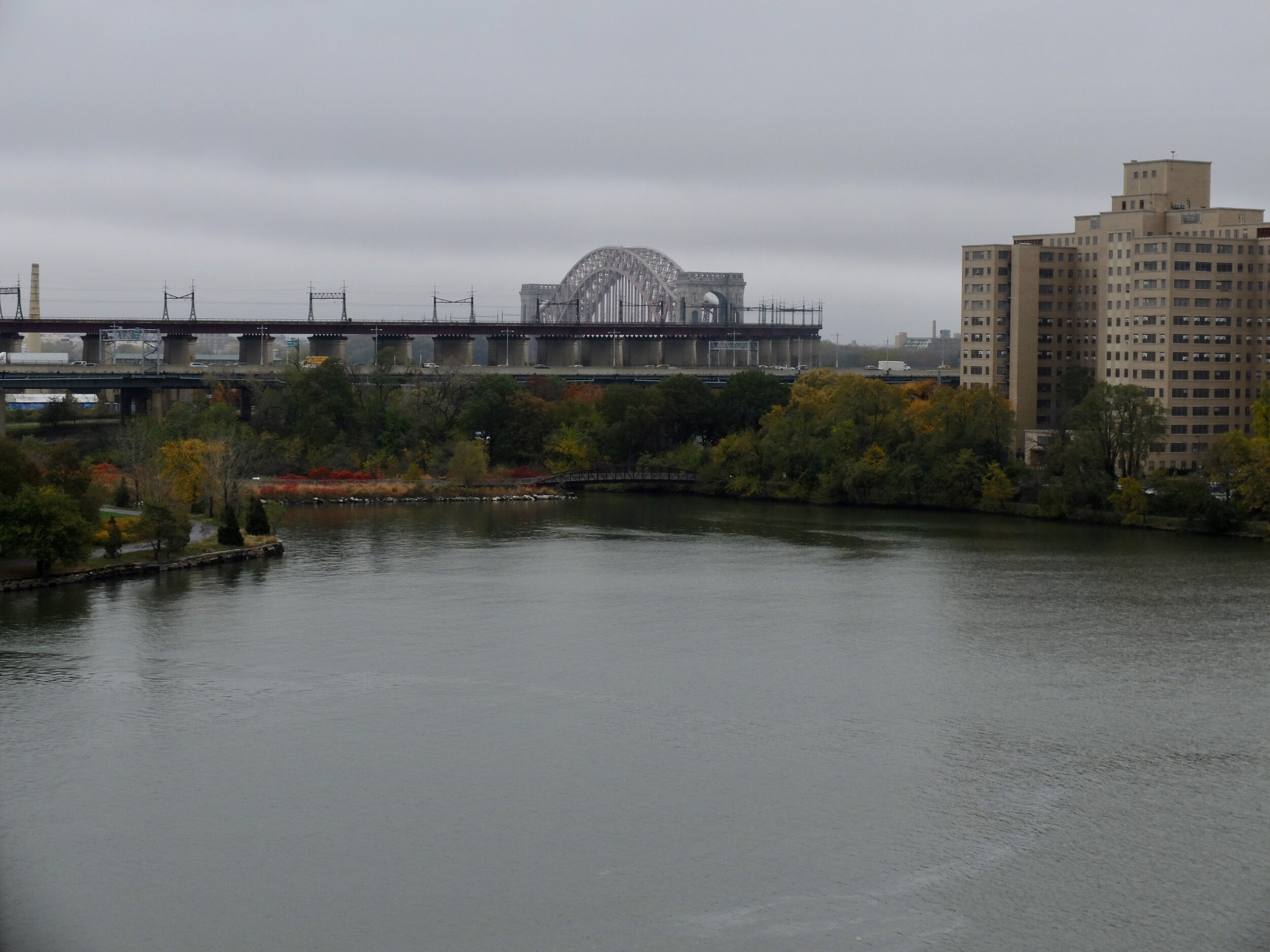 From East River Plaza looking east. The Hell Gate (railroad) Bridge circa 1912 over the East River.