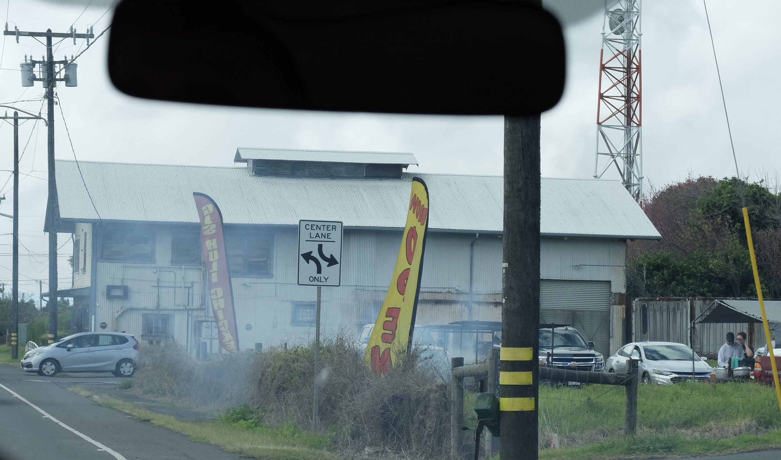 A roadside stand BBQ'ing chicken.