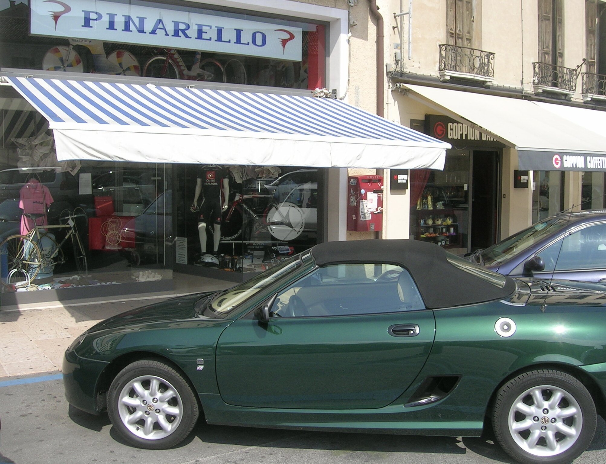  In the small Italian town of Treviso, a perfect looking bike shop, Pinarello Accessories Shop. There even was a MG parked in front.  I was salivating for that retro styled pink jersey (maglia rosa) but alas the shop was closed &amp; the MG wasn't fo