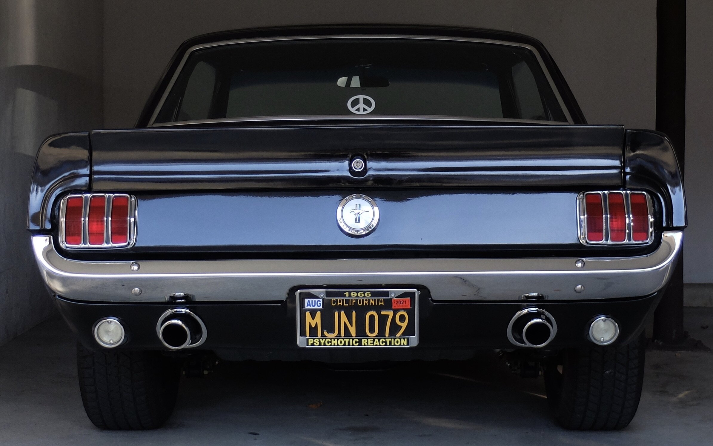 In the license plate frame, the year could be 2020 vs. 1966.