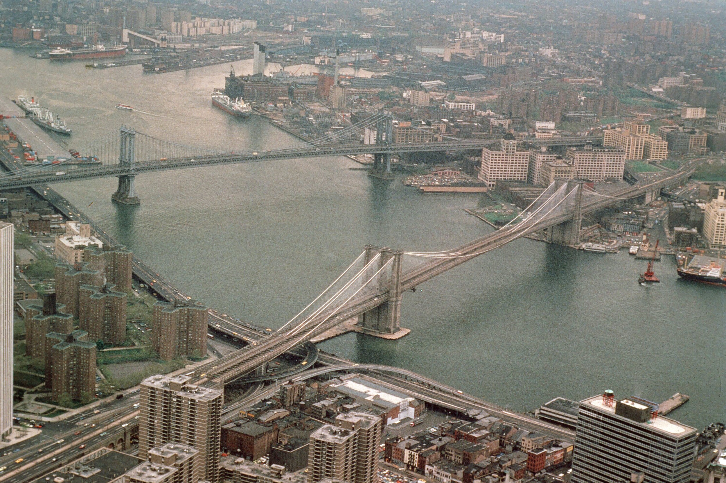  Taken from atop the Empire State Bldg, 1978.  The Manhattan Bridge is to the left, with DUMBO underneath.  The area between it &amp; the Brooklyn Bridge is the new Brooklyn Bridge Park.   You can make out the clock tower building between the bridges