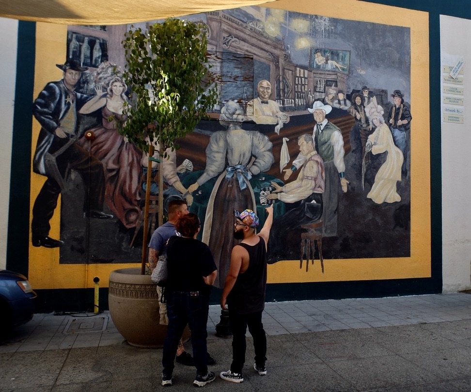 And across the alley a mural of drinking, gambling...