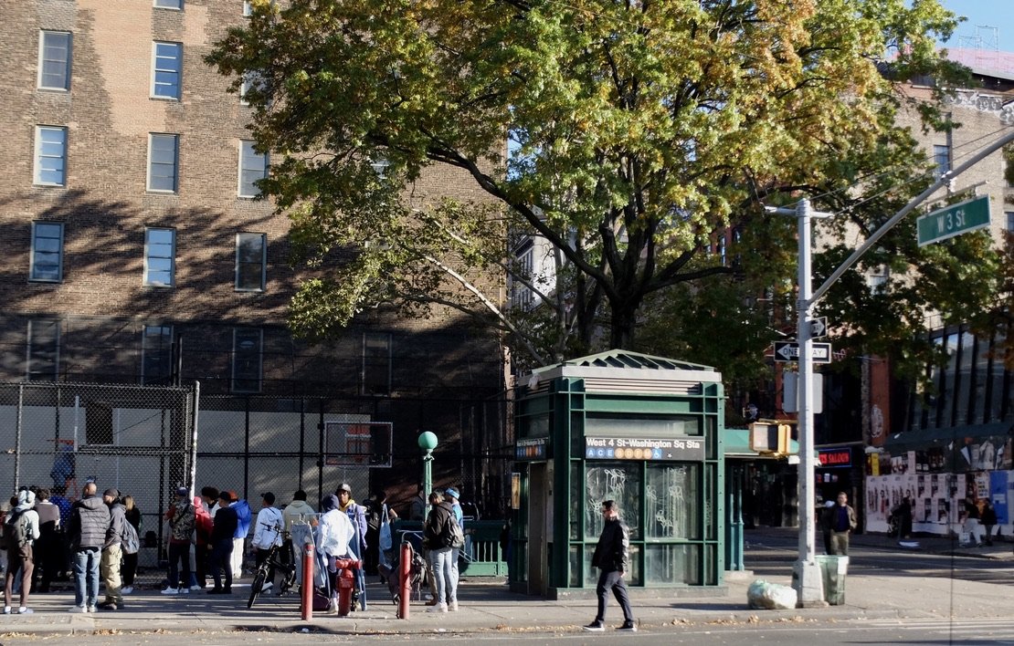 A filming of some sort was occurring in the playground next to the subway station.