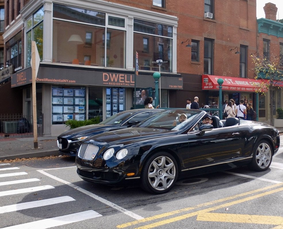 Two bro's playing loud music in this Bentley.